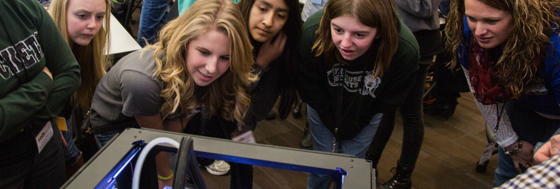 Students viewing one of UNO's 3D printers