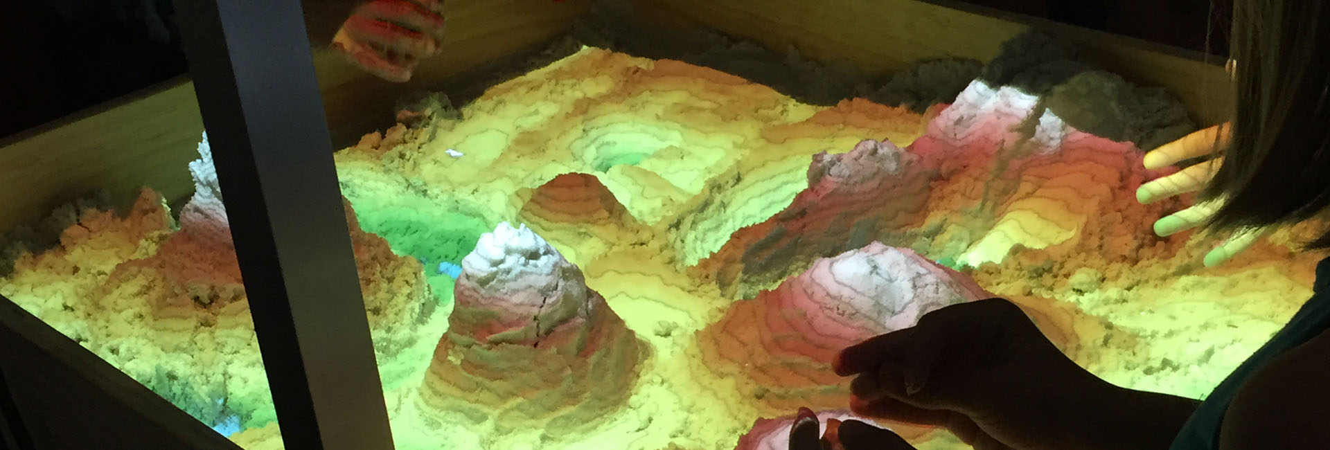 Students in the Aim for the Stars summer camp play with the Augmented Reality Sandbox.