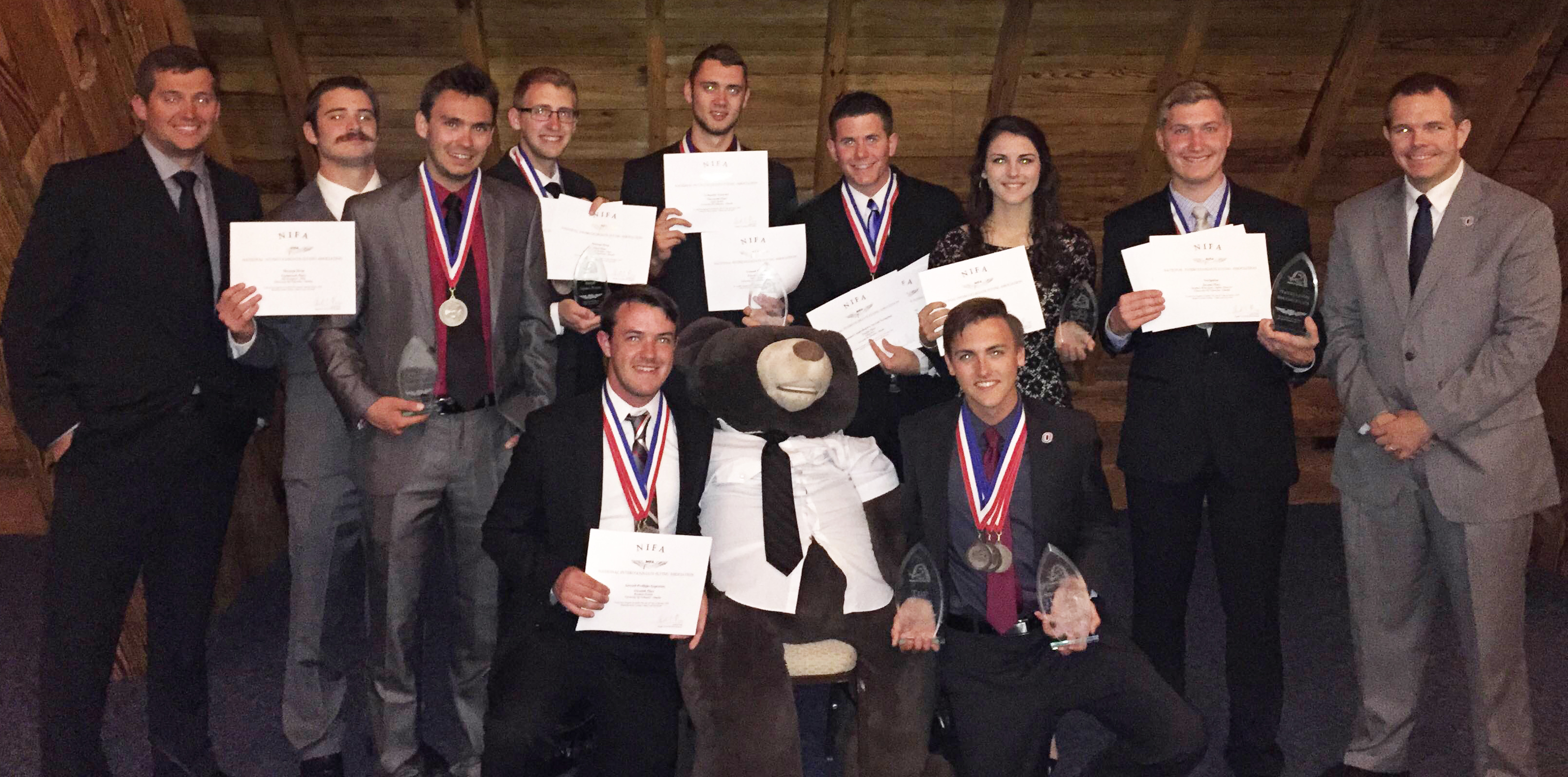 The Flying Mavs pose with their awards and unofficial mascot after the competition's awards banquet.