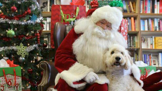 Saint Nick poses with a pup during last year's Santa Paws event.