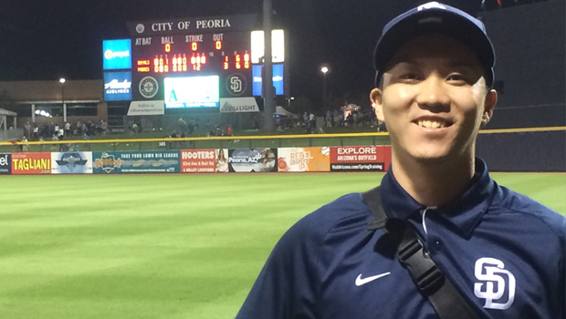 Takeaki Ando poses for a photo after a night game. 