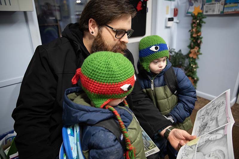Brian Lee reads to his sons Nate and Zach