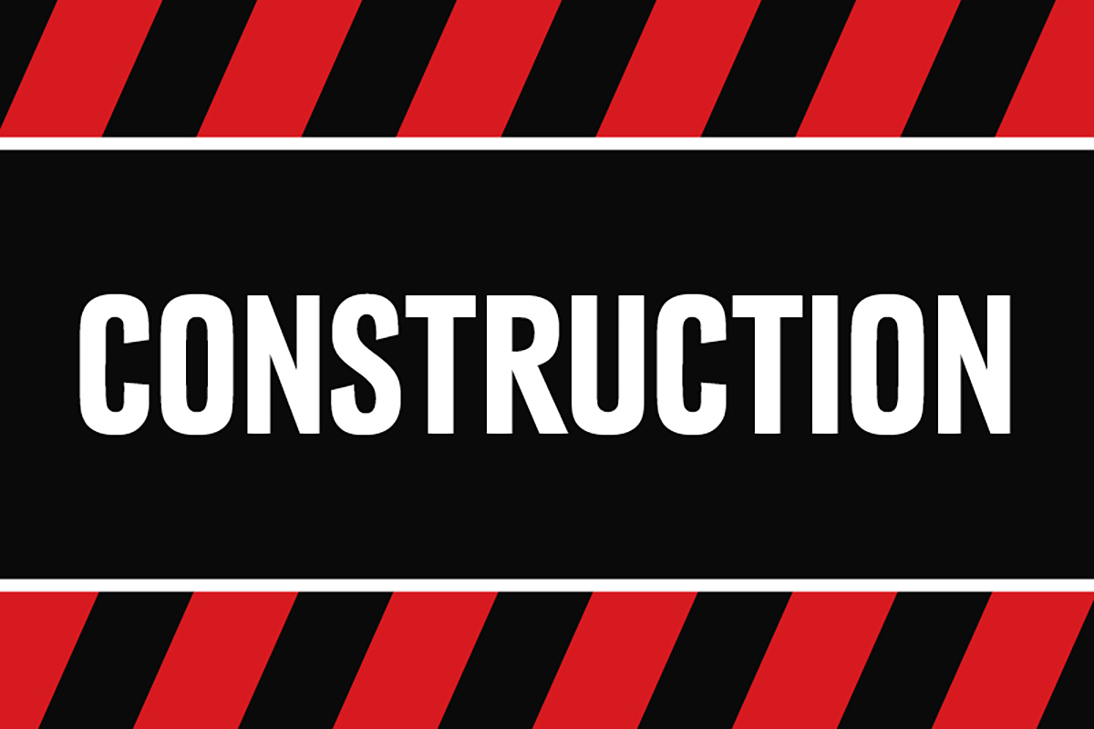 The word "Construction" with red and black emergency tape lines.