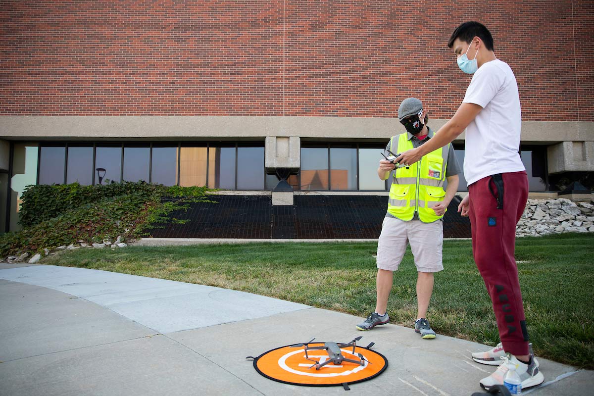 UNO Aviation Institute students John Koch, left, and Jason Chan record photos and video with a drone over campus at the University of Nebraska at Omaha