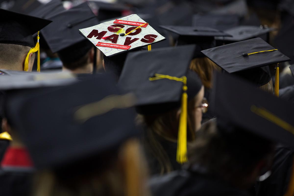 A photo of a commencement mortarboard with "Go Mavs" on it