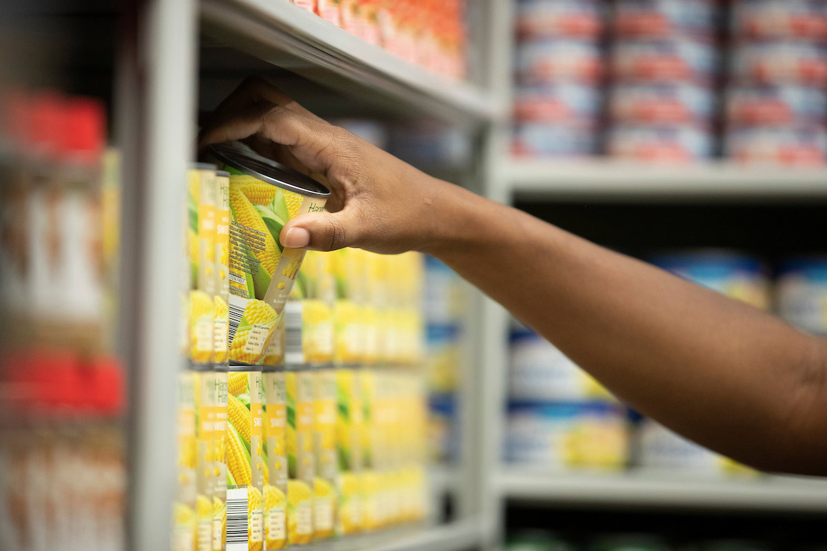 A student selects items off the shelves in the Maverick Food Pantry