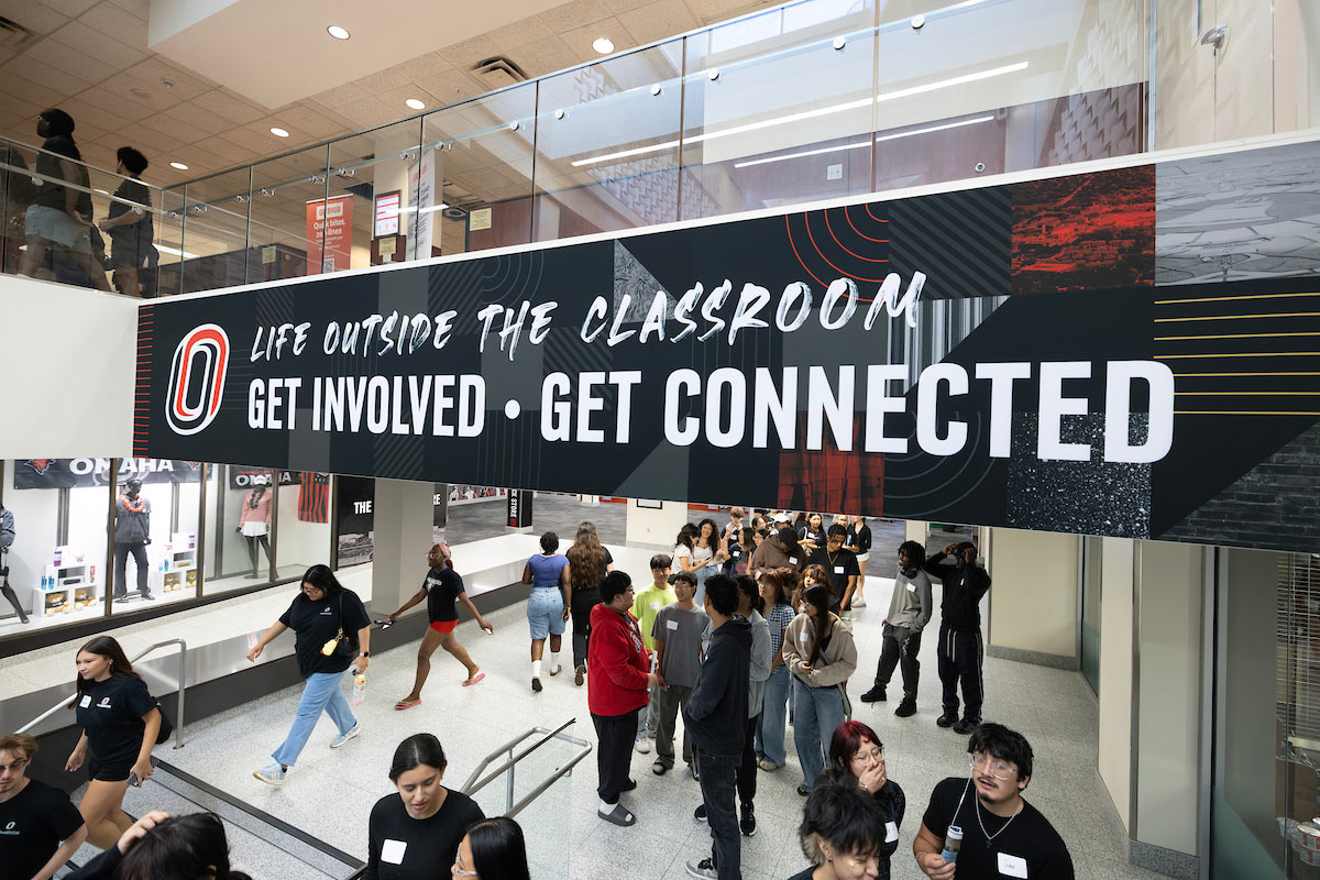 Students walk through the Milo Bail Student Center under a "Life Outside the Classroom" banner.