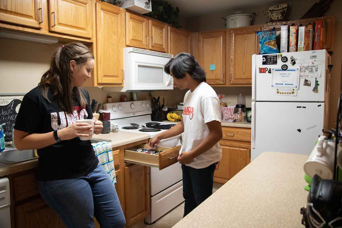 Students discuss in the kitchen of a Scott Village housing unit.