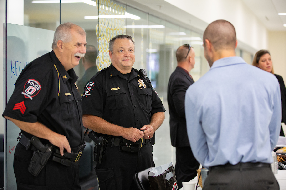 Dave Points and Mike Murphy talk with a student during "Coffee With Cop"