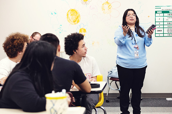 Education student leads an activity with children in a classroom.