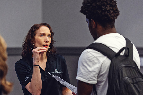 A student speaks with a group during an admissions session.