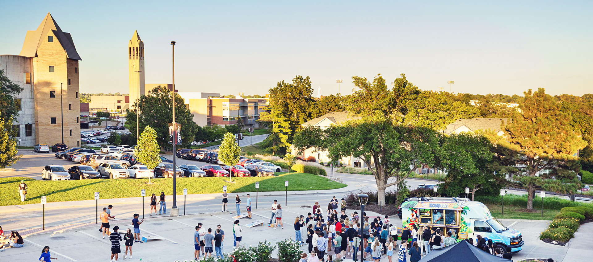 Students walk across the plaza during a campus event on a sunny day.