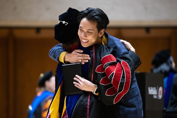 Chancellor Li hugs a student during the UNO Student Honors Convocations Ceremony