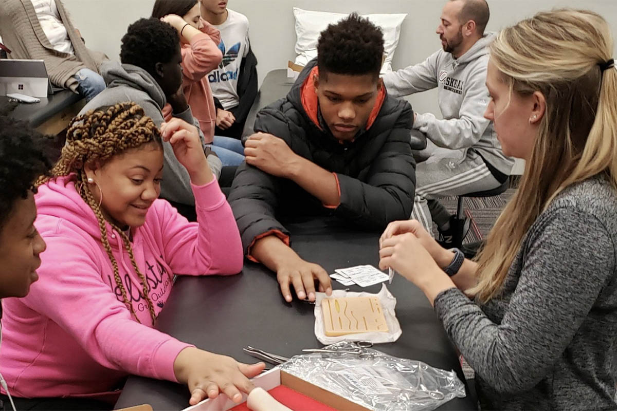Benson Health Professions Academy students work with UNO Athletic Training students on a suturing simulation activity in the Athletic Training Lab at UNO.