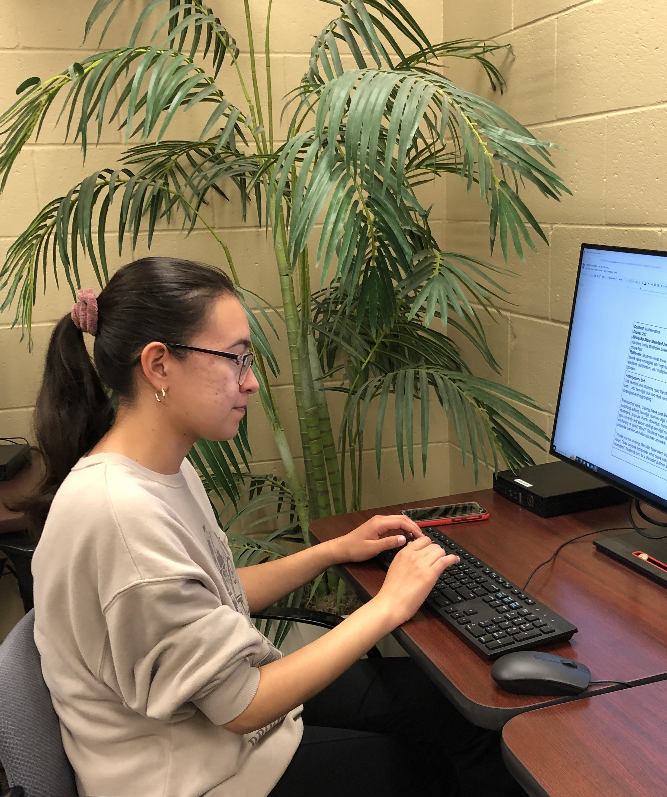 An Honors student answering questions about her symposium poster