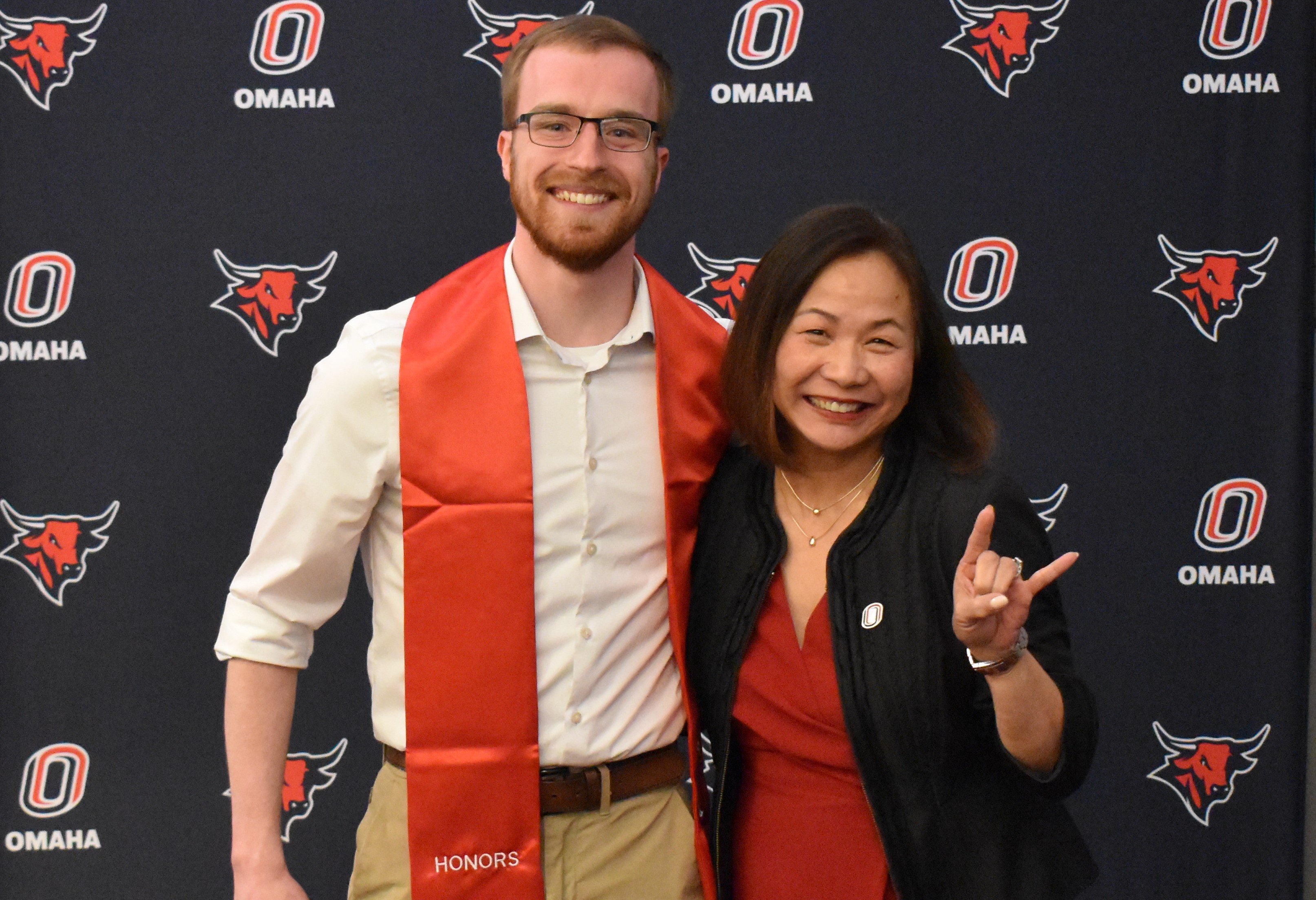 New Honors graduate standing beside Chancellor