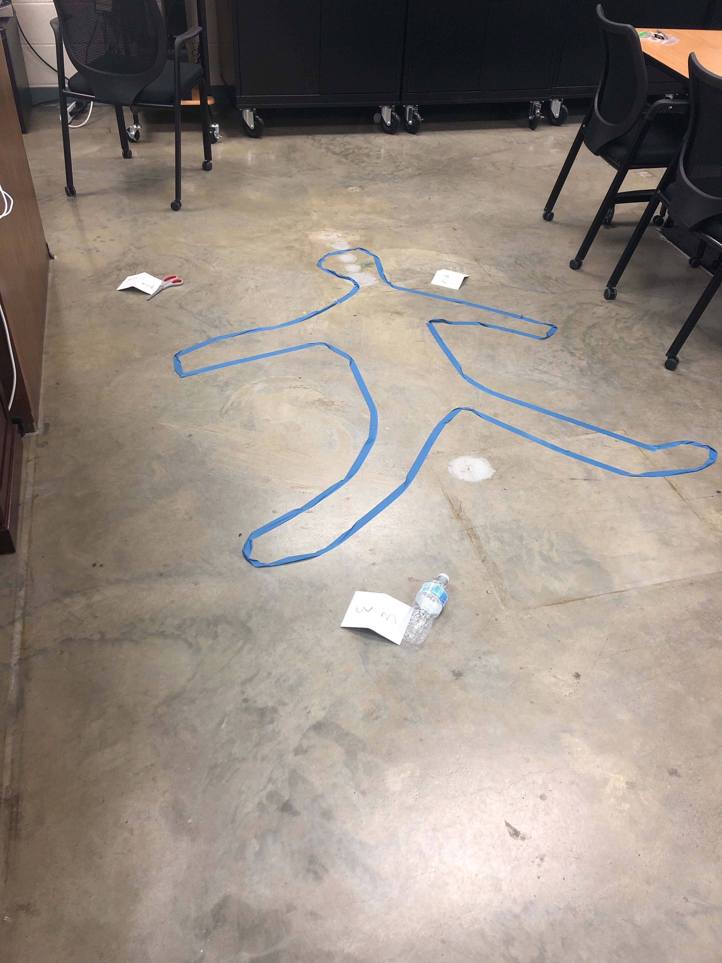 Image of a body outlined in tape 