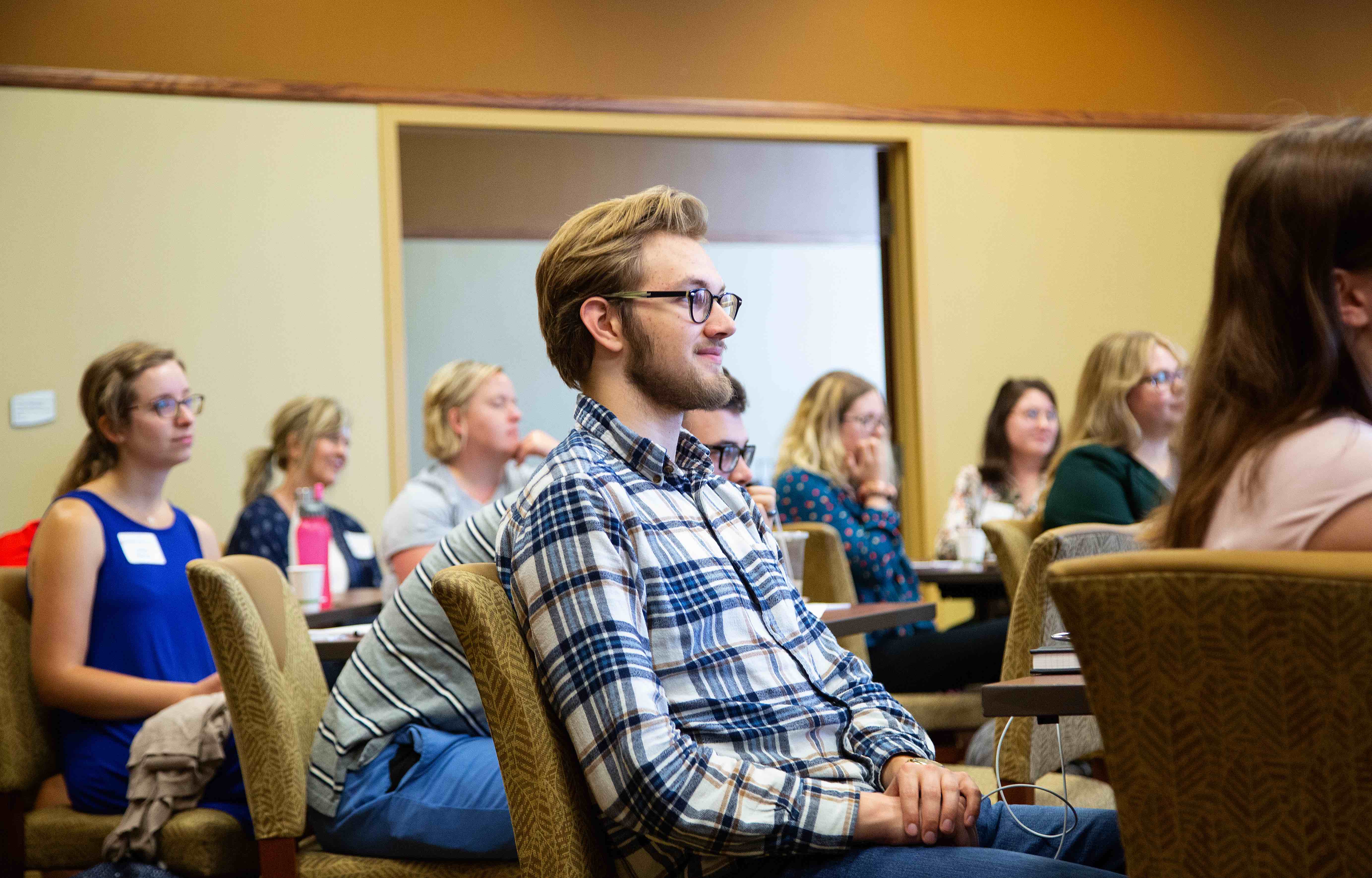 Photo of a student watching a speaker