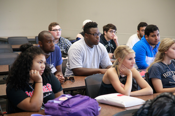 a diverse group of students sits in a classroom