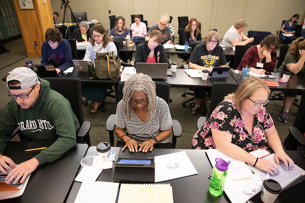 a group of students writing on their laptops