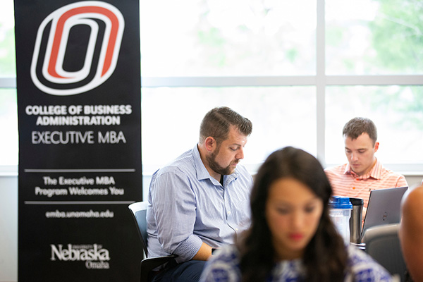 students sit in an executive mba class at uno