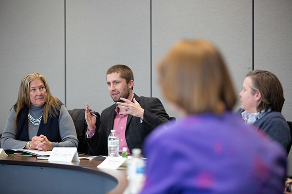 a group of people sit at a table and talk