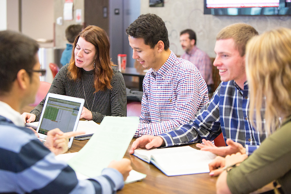 students sit at a table studying