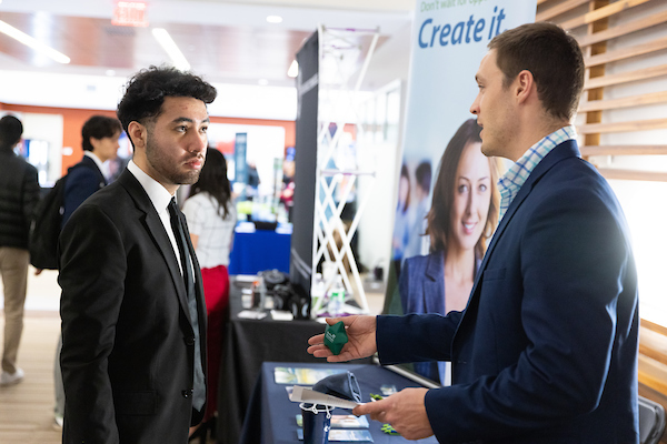 two people speaking at a career fair