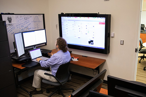 a man sites working at a computer