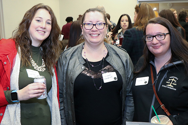 women in criminal justice stand together smiling at the camera