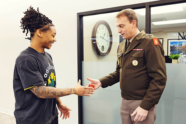 A UNO staff member talks with a military-connected student in uniform.