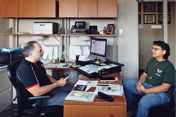 A student talks with a Financial Support Counselor in an office.