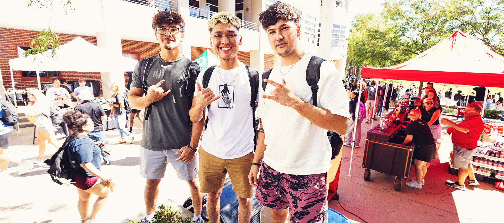 three students outside on the first day of class