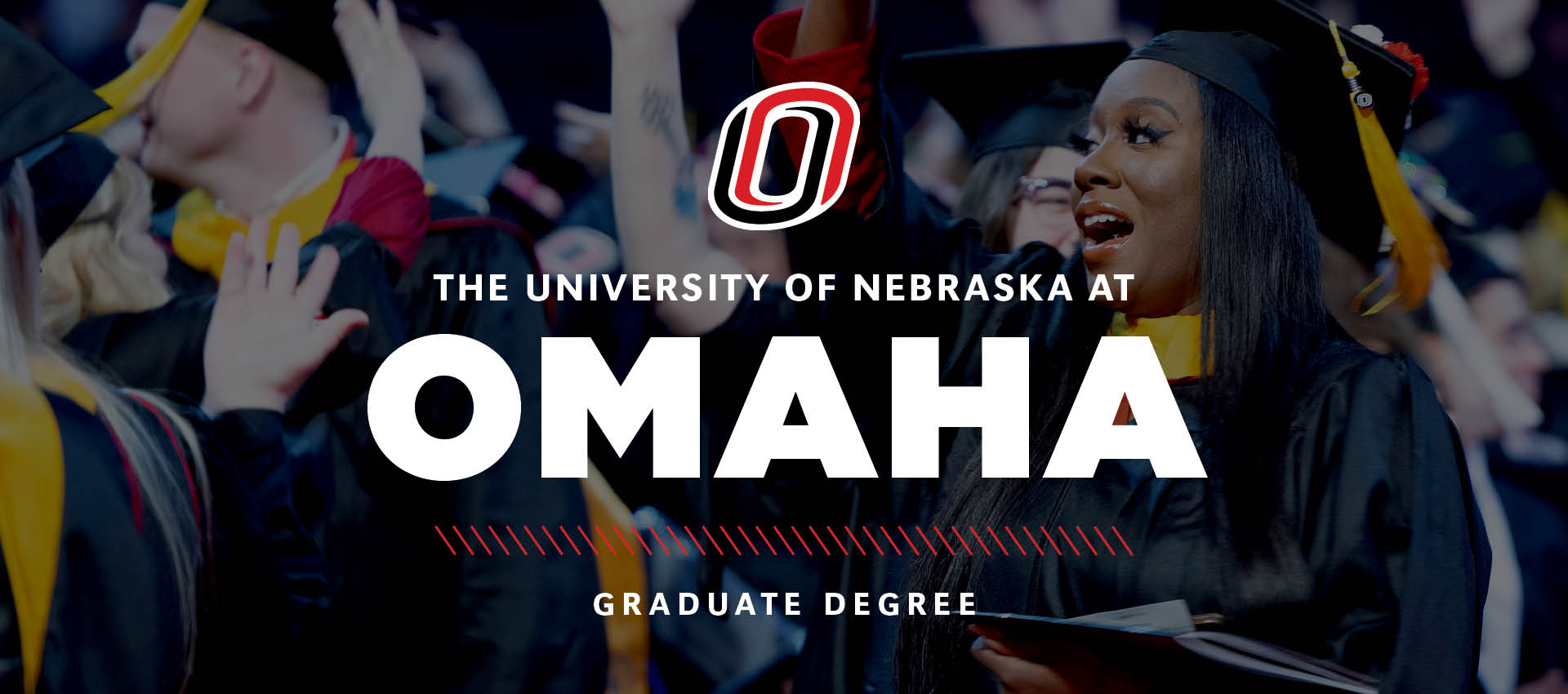ChatGPT said:  A graduate in a cap and gown smiles and raises her hand during the University of Nebraska at Omaha commencement ceremony, with “The University of Nebraska at Omaha Graduate Degree” text overlaid on the image.