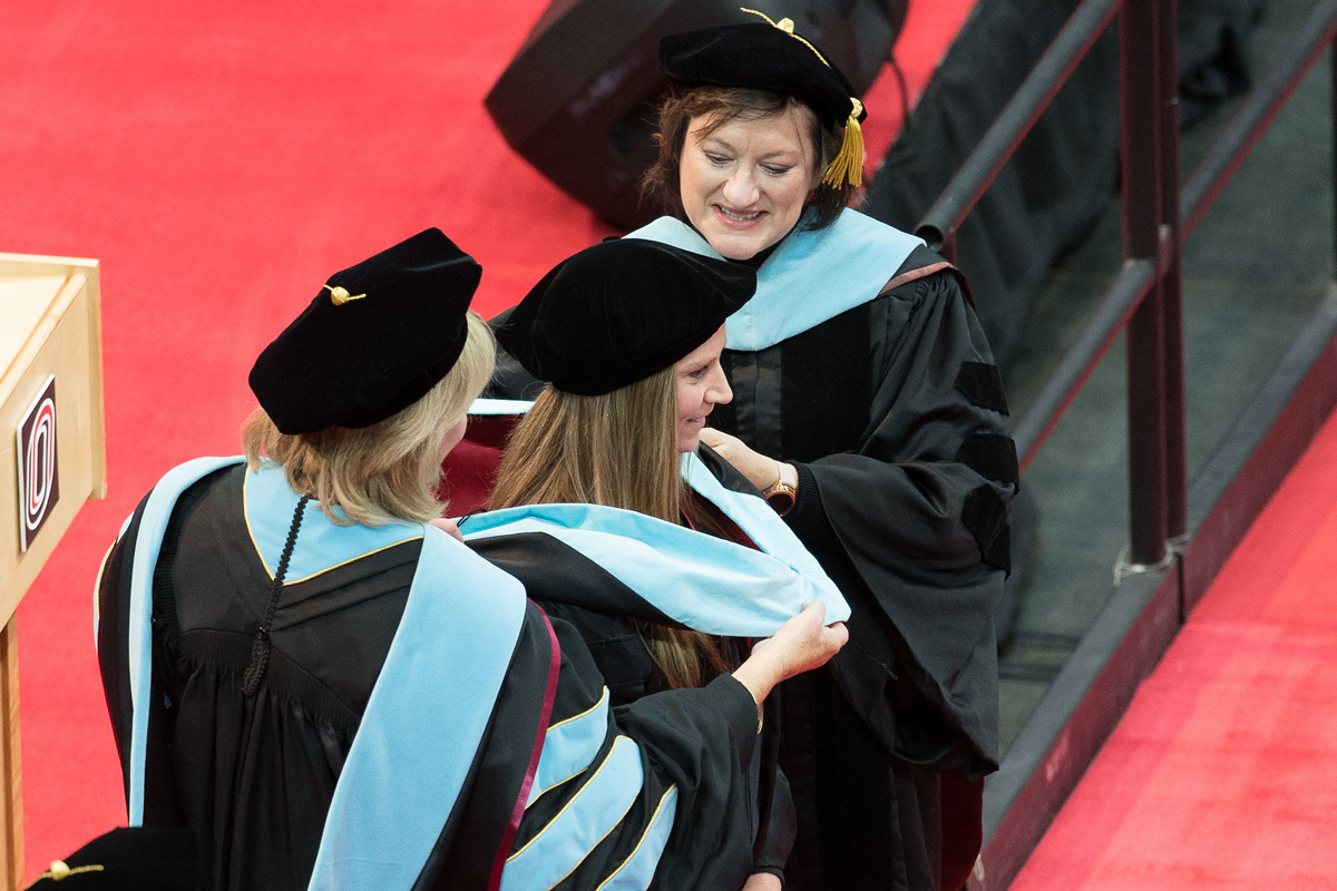 graduate receiving their degree at commencement ceremony