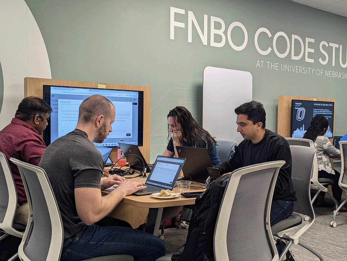 students working on laptops in class.