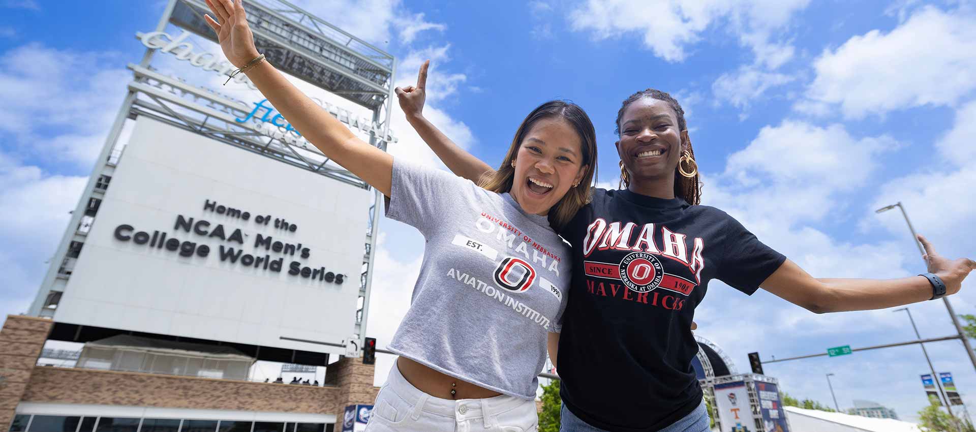 Two female students in front of the CWS stadium