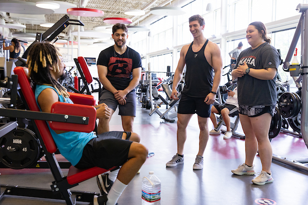 people talking ans laughing in a gym.