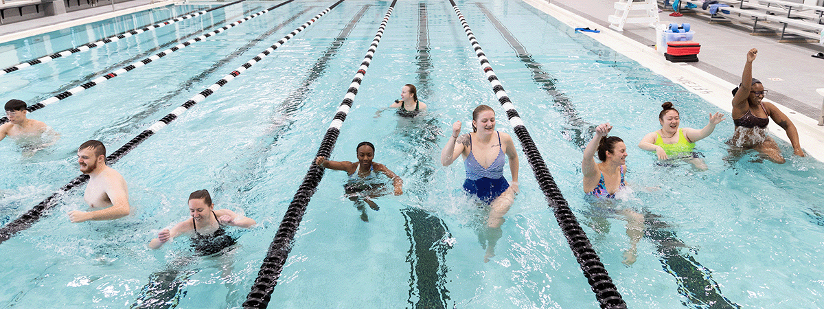 men and women enjoy uno's swimming pool.