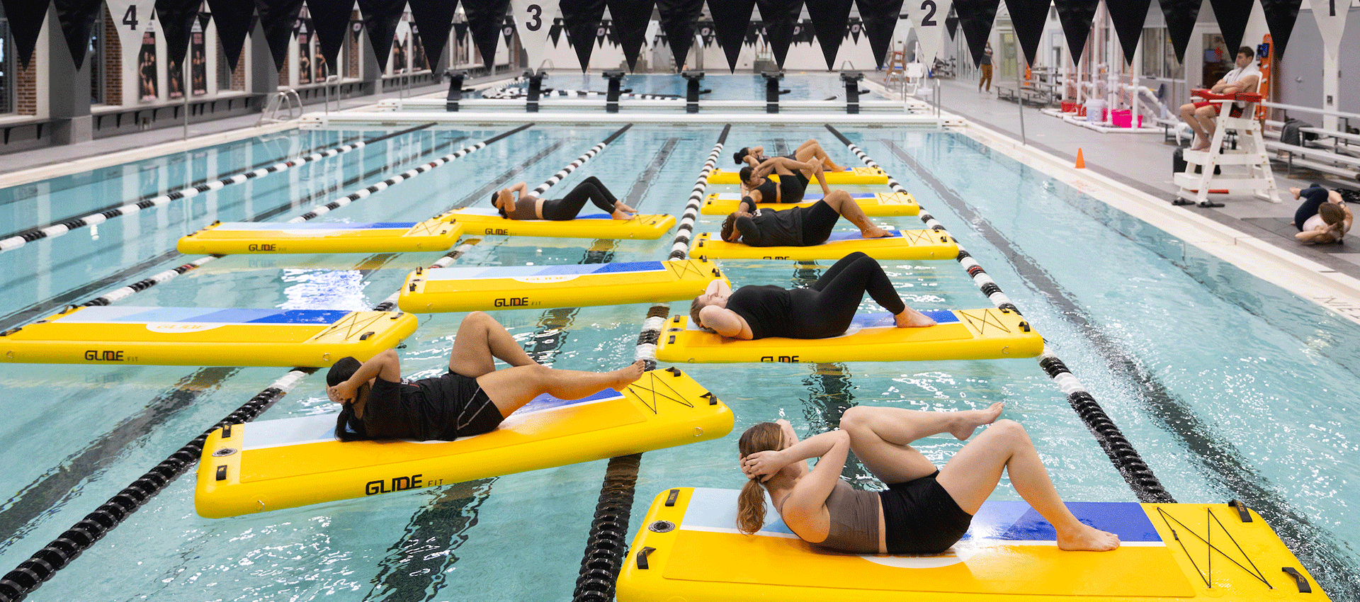 participant perform yoga as they float on rafts in the uno pool