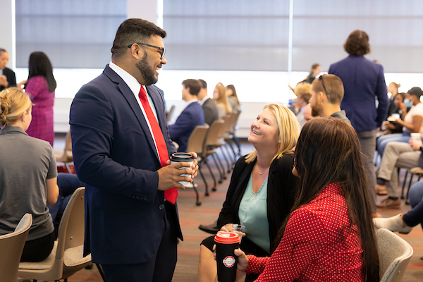 student talking with business owners