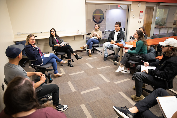 students sitting in a circle in a discussion