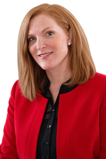Dr. Anne E. Herman wearing a red blazer suite, facing the camera.