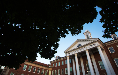 Arts and Sciences Hall framed by trees.