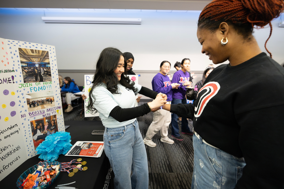 two students meeting at a student organization discovery event