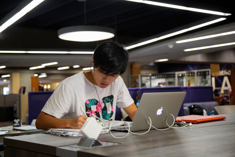 student studying in quiet area with laptop
