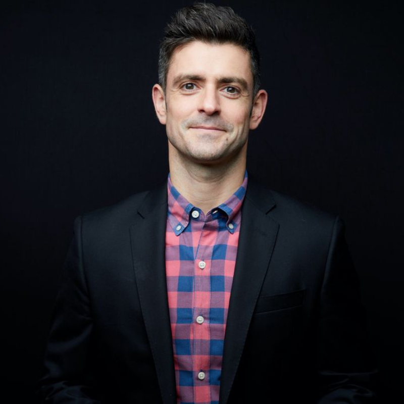 Daniel Erker poses in front of a black background.