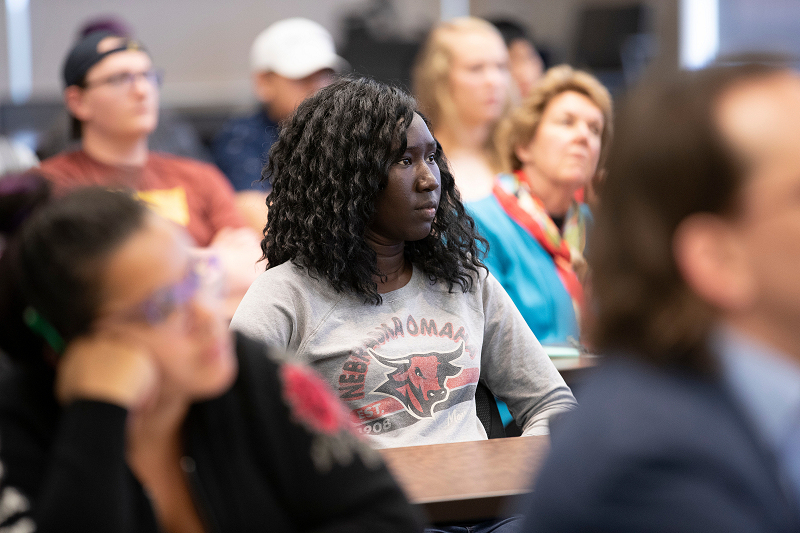 Image of student seated at an event.