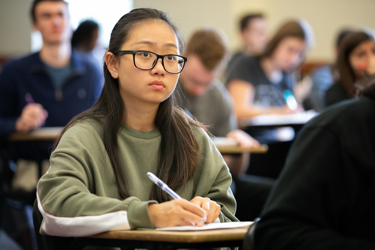 Student taking notes in class