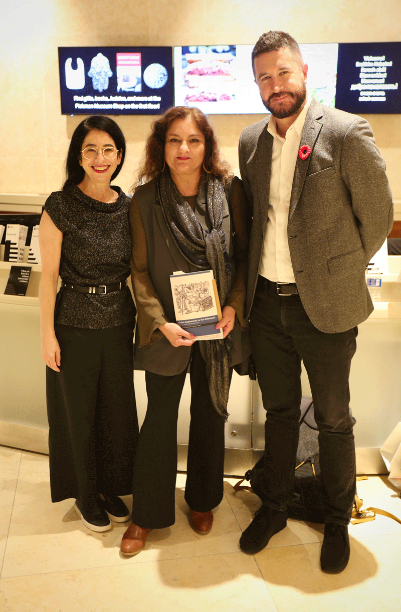 Dr. Mark Celinscak stands with Mehnaz Afridi and Dr. Laura B. Cohen at a book event, Mehnaz Afridi is holding a copy of their book